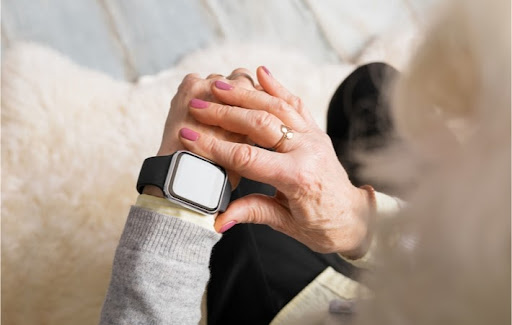 A womanchecking her smartwatch, which can be useful for senior health applications such as tracking and reminders
