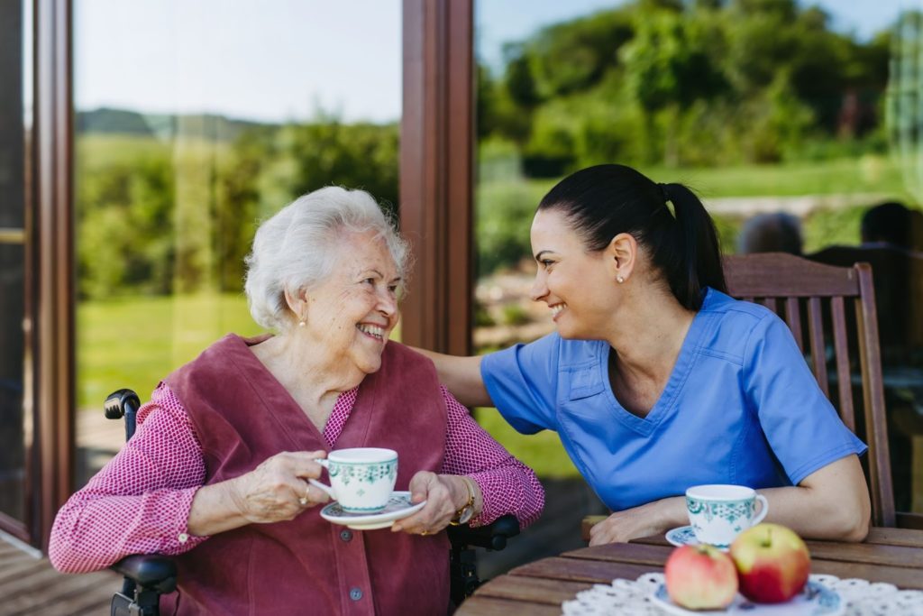 A care staff connects with an older adult in assisted living.