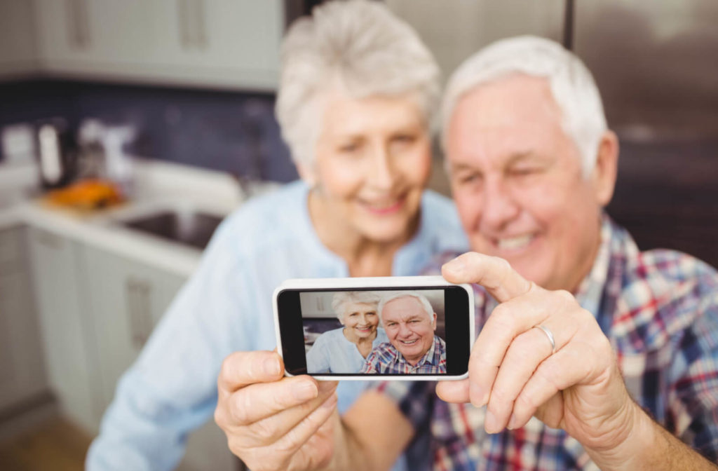 a senior couple take a selfie with their cell phone