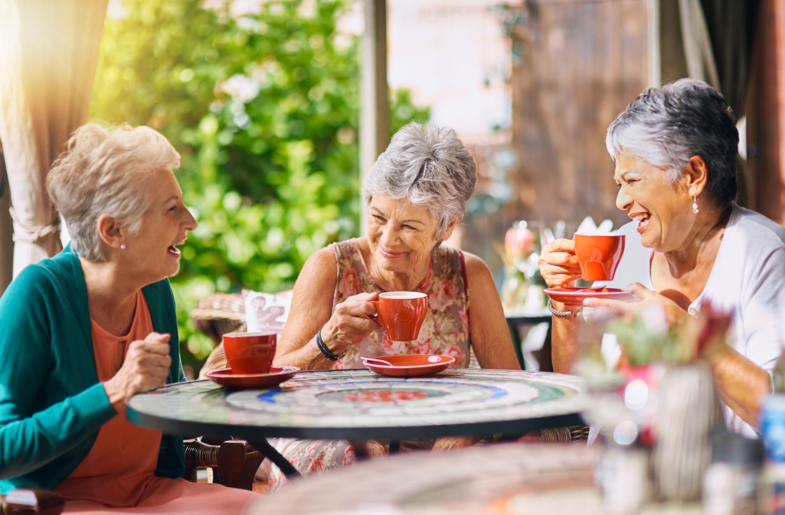 Seniors enjoying a café space as an amenity in an assisted living community.