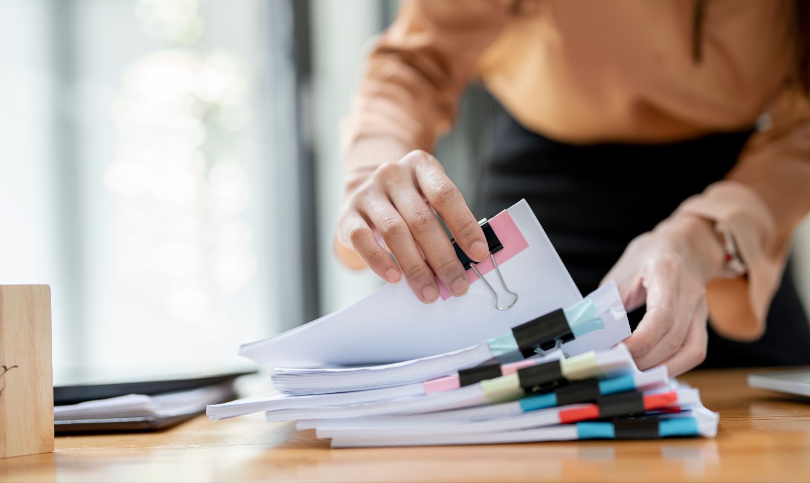 A woman searching through the sections of a well-organized business plan.