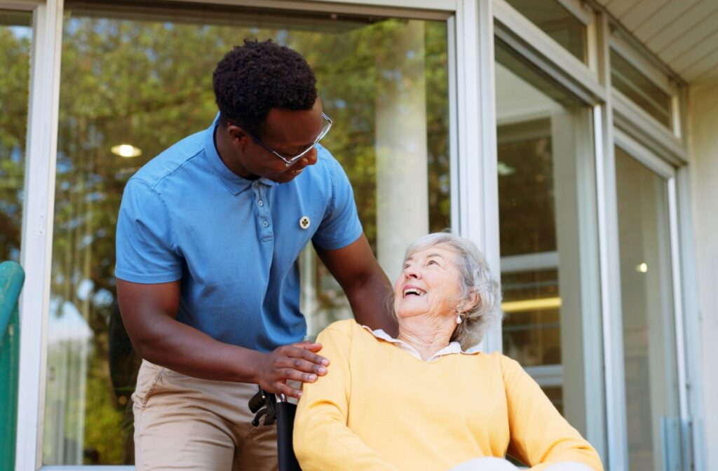 A happy caregiver goes for a walk with a senior resident in assisted living.